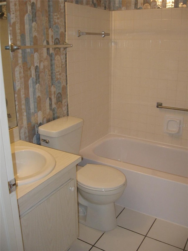 full bathroom featuring tile patterned flooring, vanity, toilet, and tiled shower / bath