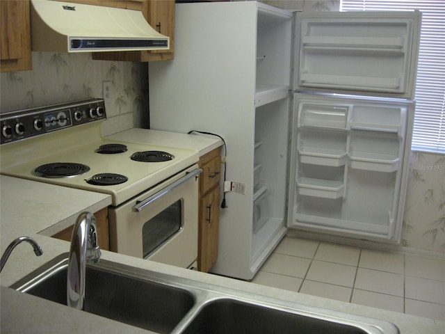 kitchen with light tile patterned flooring and white range with electric stovetop