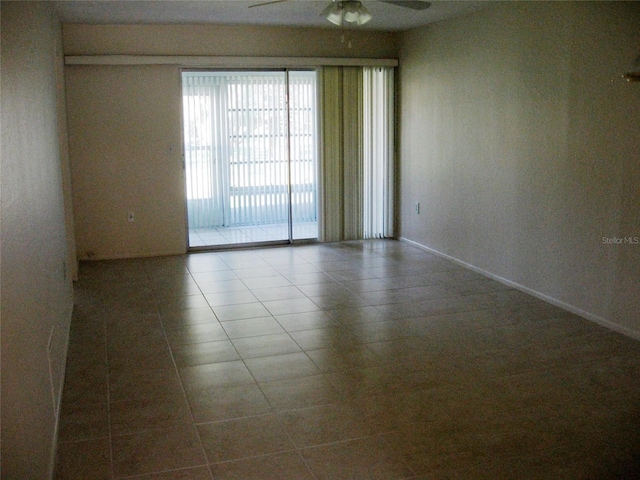 empty room with ceiling fan and tile patterned floors