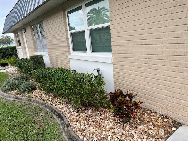 11920 Boynton Ln Unit 11920, New Port Richey, FL 34654 - view of property exterior featuring brick siding and metal roof