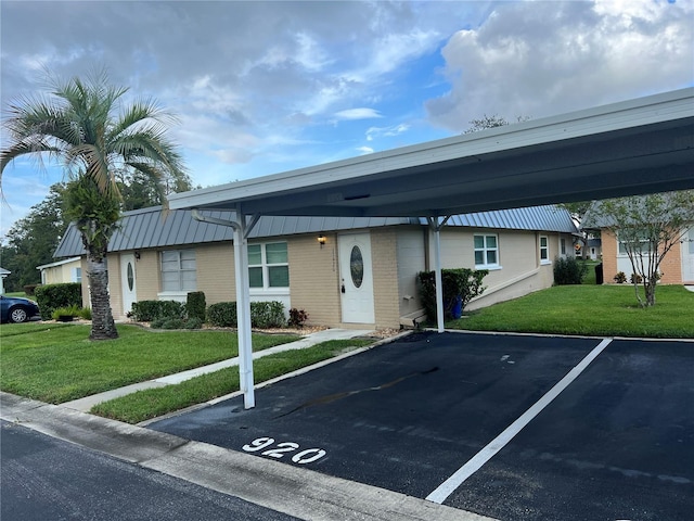 11920 Boynton Ln Unit 11920, New Port Richey, FL 34654 - view of front of home with brick siding, covered and uncovered parking, and a front lawn
