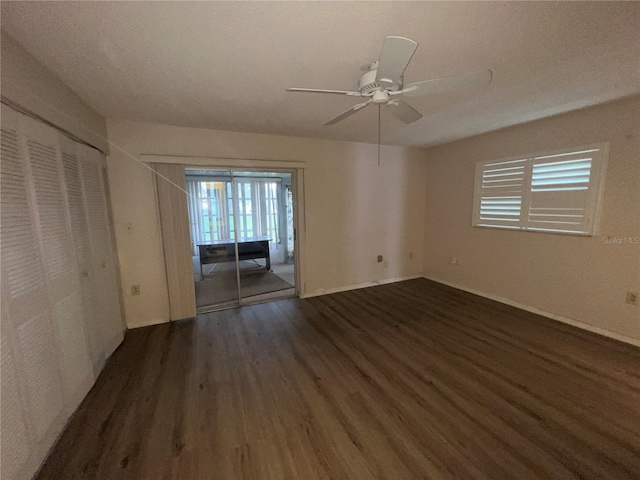 empty room featuring ceiling fan and dark hardwood / wood-style floors