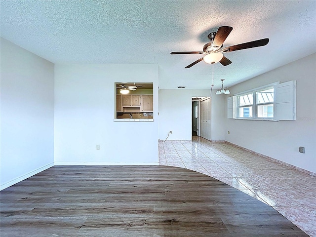11920 Boynton Ln Unit 11920, New Port Richey, FL 34654 - unfurnished living room with a ceiling fan, wood finished floors, and a textured ceiling