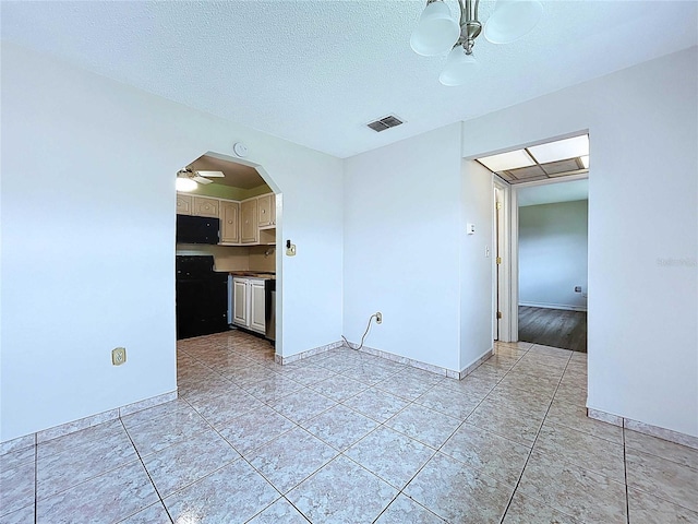 11920 Boynton Ln Unit 11920, New Port Richey, FL 34654 - spare room with arched walkways, a ceiling fan, visible vents, and light tile patterned flooring