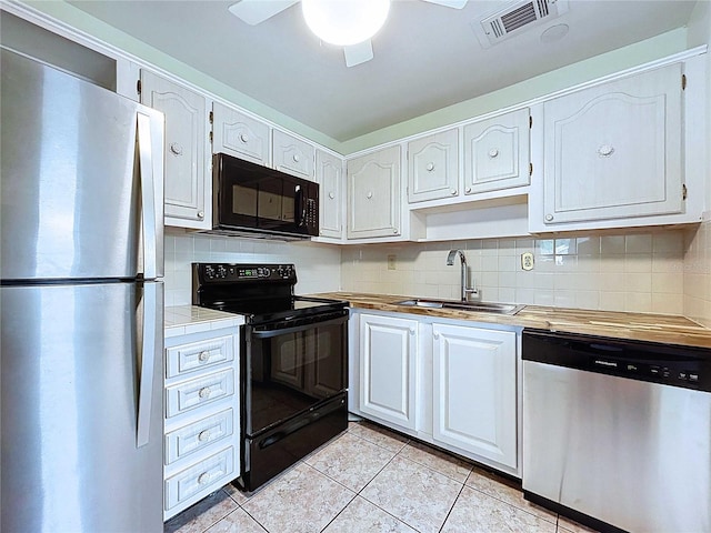 11920 Boynton Ln Unit 11920, New Port Richey, FL 34654 - kitchen with a sink, visible vents, backsplash, black appliances, and light tile patterned floors