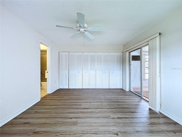 11920 Boynton Ln Unit 11920, New Port Richey, FL 34654 - interior space featuring baseboards, access to outside, wood finished floors, and a textured ceiling