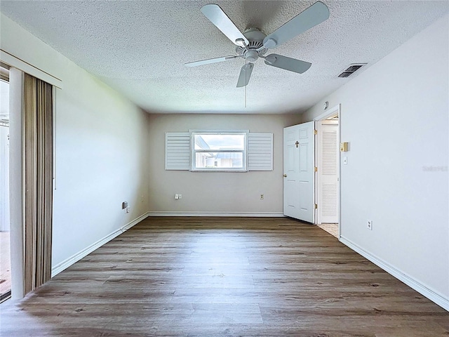 11920 Boynton Ln Unit 11920, New Port Richey, FL 34654 - interior space featuring wood finished floors, visible vents, baseboards, a textured ceiling, and ceiling fan