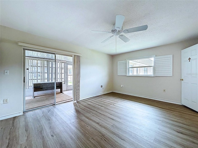 11920 Boynton Ln Unit 11920, New Port Richey, FL 34654 - unfurnished room with wood finished floors, a textured ceiling, and plenty of natural light