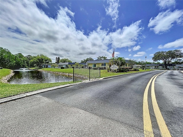 11920 Boynton Ln Unit 11920, New Port Richey, FL 34654 - view of road with a gated entry, curbs, and a water view