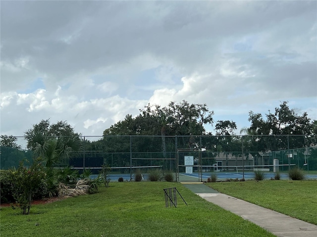 11920 Boynton Ln Unit 11920, New Port Richey, FL 34654 - surrounding community with fence, a lawn, and a tennis court