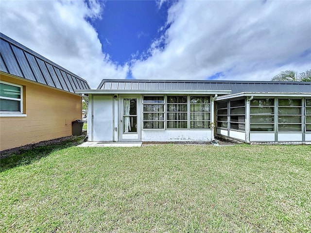 11920 Boynton Ln Unit 11920, New Port Richey, FL 34654 - rear view of house featuring a sunroom, concrete block siding, and a yard