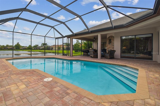 view of swimming pool featuring a water view, a patio, and a lanai