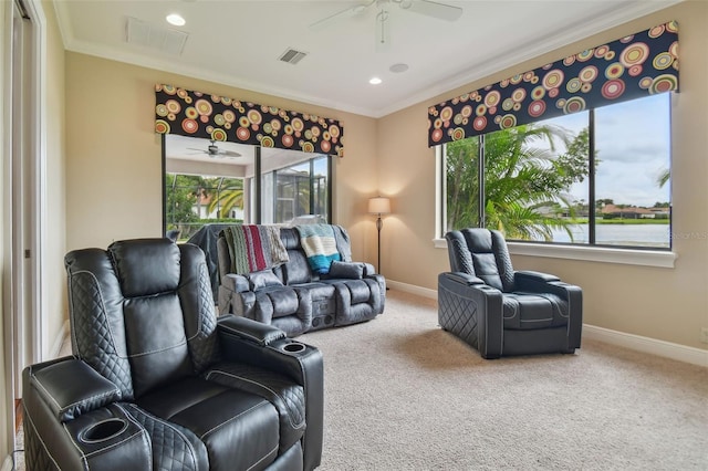 carpeted living room featuring crown molding and ceiling fan