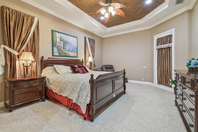 carpeted bedroom featuring ornamental molding, ceiling fan, and a tray ceiling