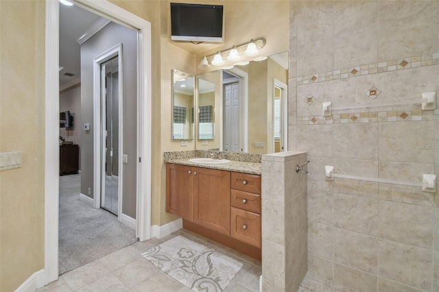 bathroom featuring ornamental molding, tile patterned flooring, and vanity