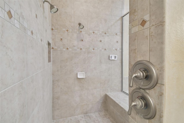 bathroom with a tile shower