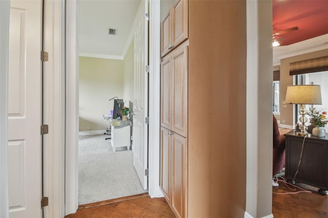 corridor with wood-type flooring and crown molding