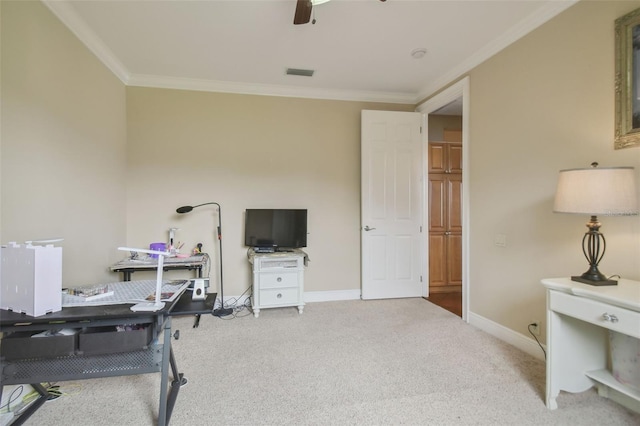 home office featuring ceiling fan, light colored carpet, and ornamental molding