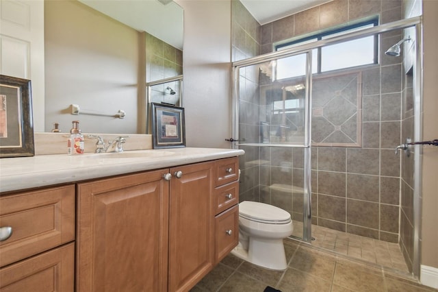 bathroom with tile patterned flooring, toilet, a shower with door, and vanity