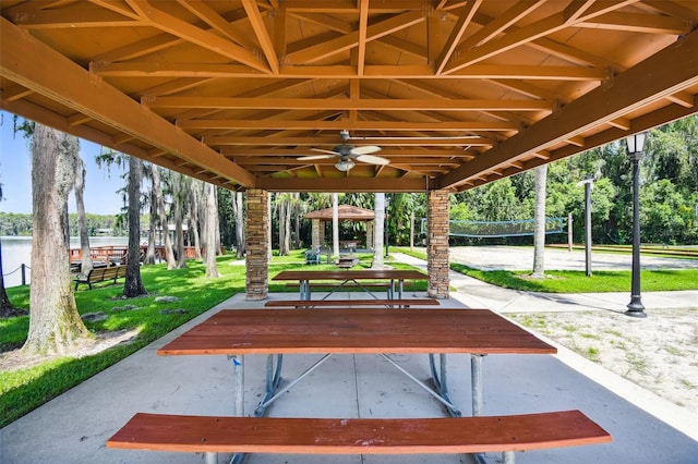 view of property's community featuring a gazebo, a yard, volleyball court, and a water view