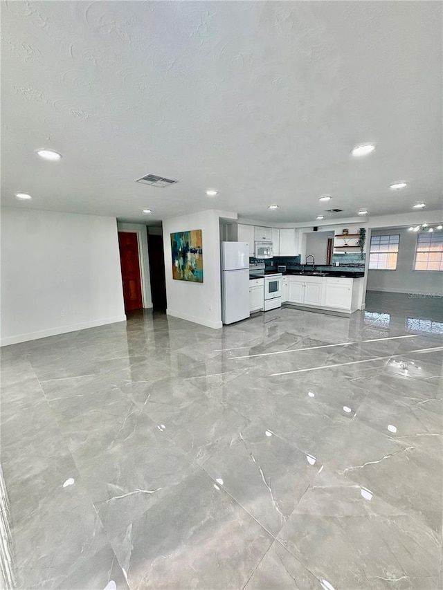 unfurnished living room featuring a textured ceiling