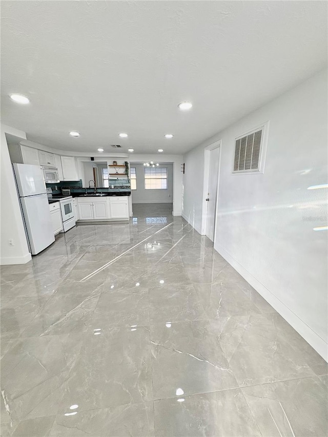 unfurnished living room featuring sink