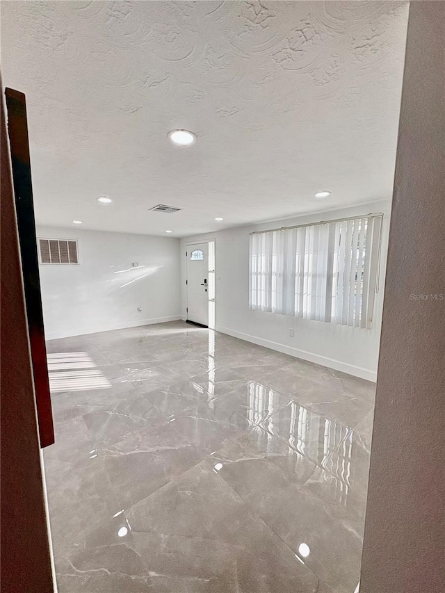 spare room with a textured ceiling