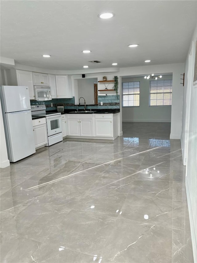 kitchen featuring white cabinetry, sink, and white appliances