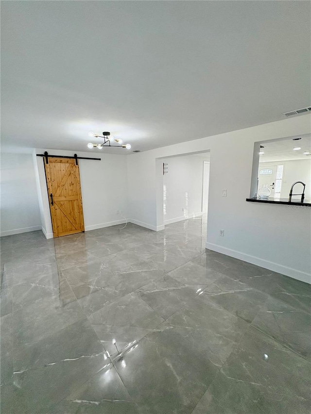 unfurnished room with a barn door