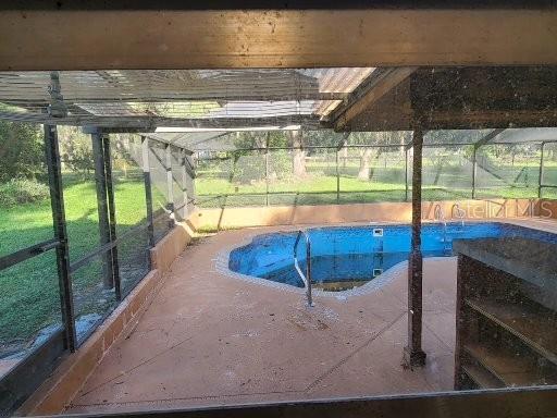 view of pool featuring a lanai and a patio