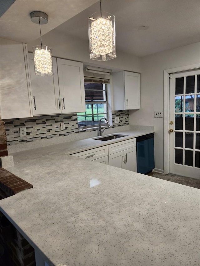 kitchen with white cabinets, sink, decorative light fixtures, and dishwasher