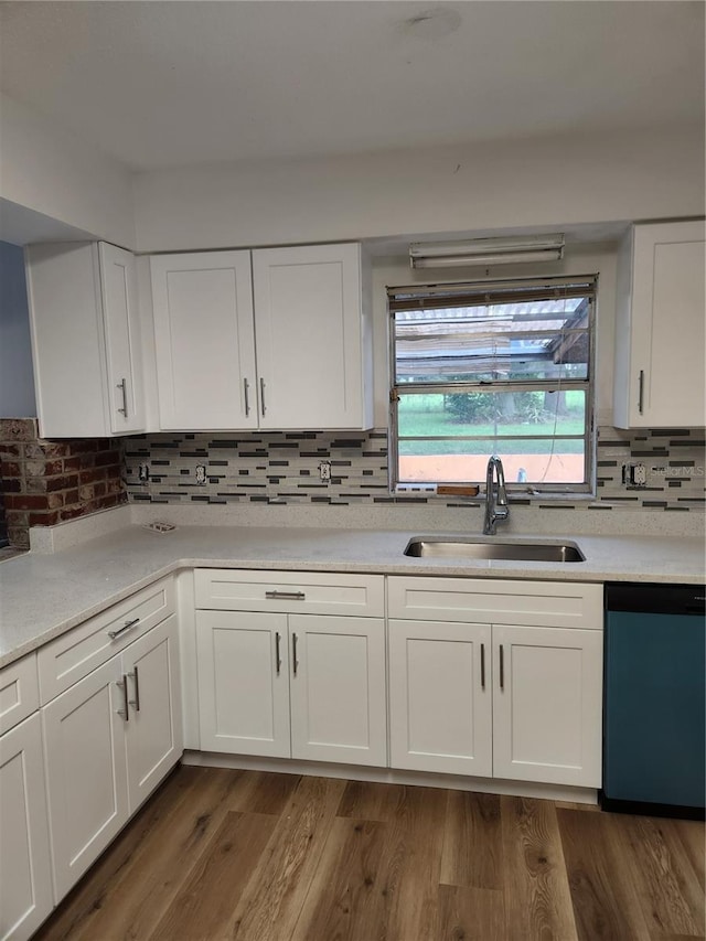 kitchen featuring dishwasher, white cabinetry, dark wood-type flooring, and sink