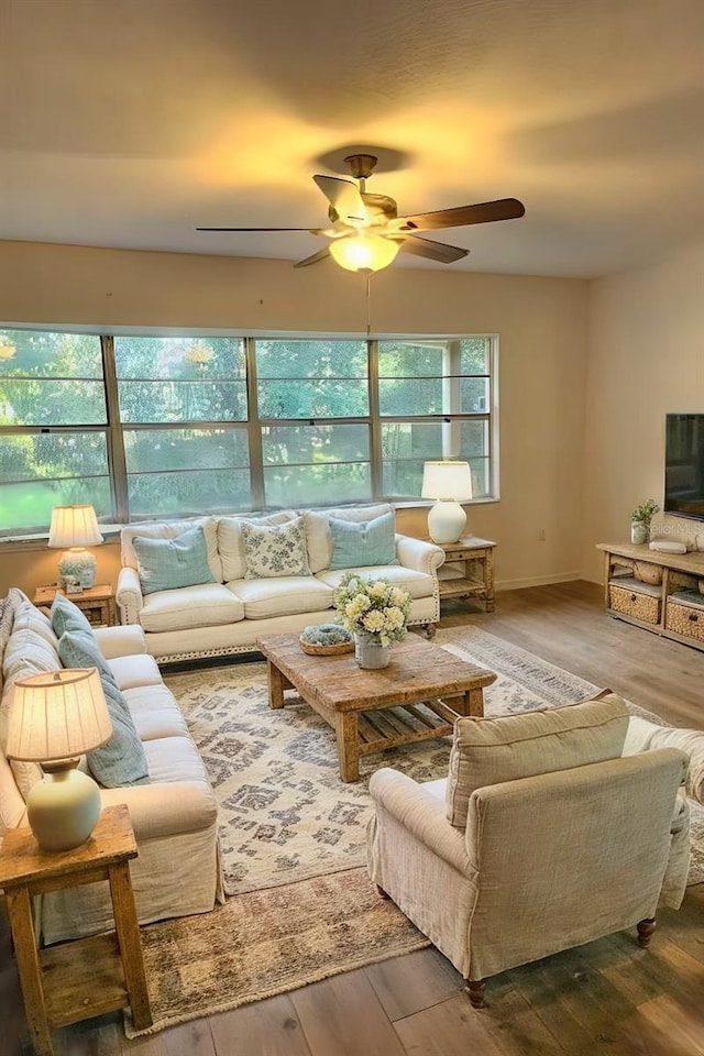 living room featuring ceiling fan and wood-type flooring