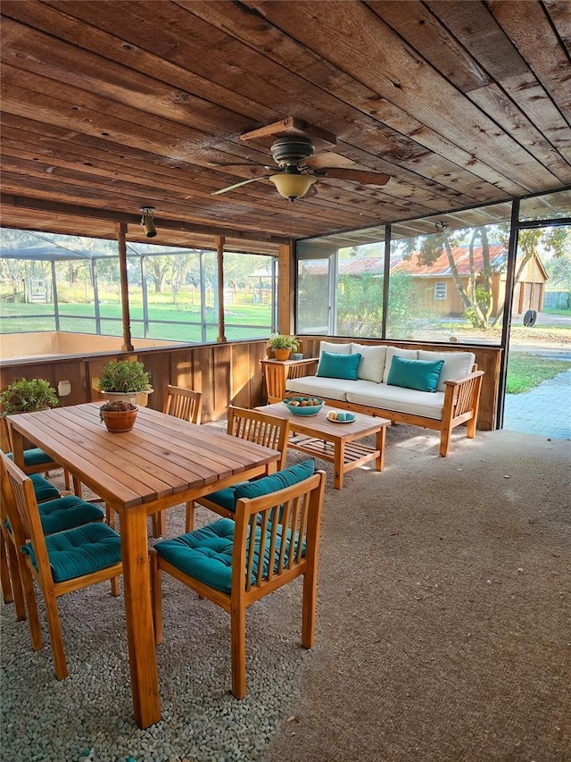 sunroom featuring wooden ceiling, ceiling fan, and plenty of natural light