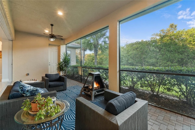 sunroom featuring ceiling fan