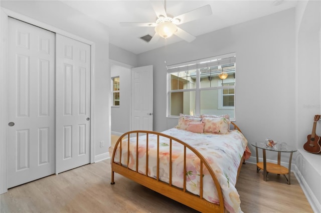 bedroom with a closet, ceiling fan, and light hardwood / wood-style floors