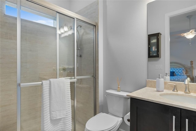 bathroom featuring vanity, toilet, and an enclosed shower