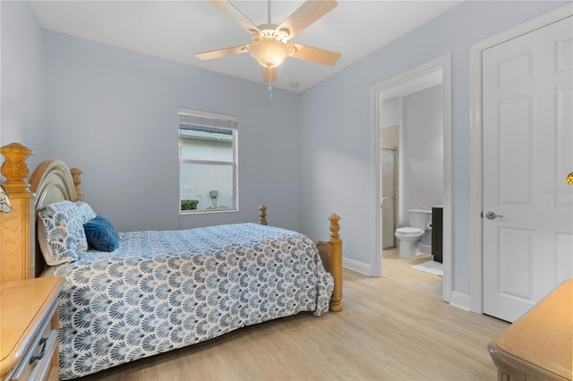 bedroom with connected bathroom, light hardwood / wood-style flooring, and ceiling fan