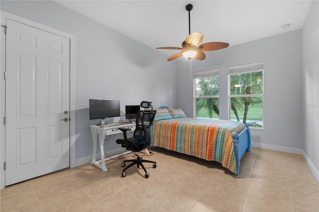 tiled bedroom featuring ceiling fan