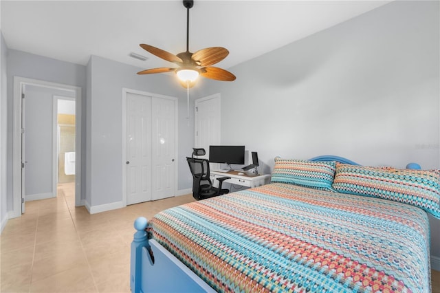 bedroom with ceiling fan, light tile patterned flooring, and a closet