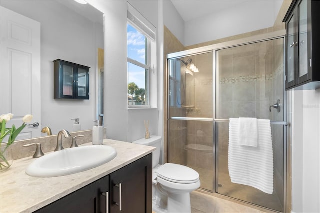 bathroom featuring vanity, toilet, and walk in shower