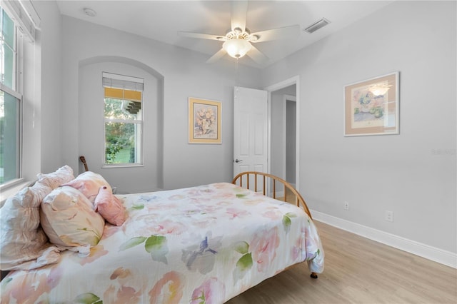 bedroom with light hardwood / wood-style floors and ceiling fan