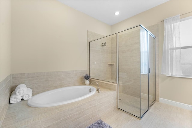 bathroom featuring plus walk in shower and tile patterned floors