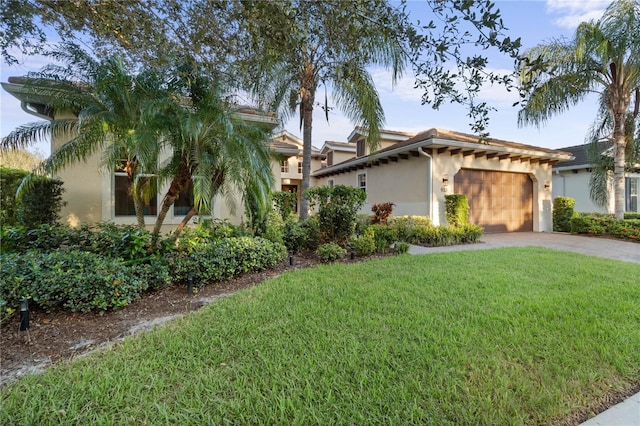 mediterranean / spanish-style house with a garage and a front yard