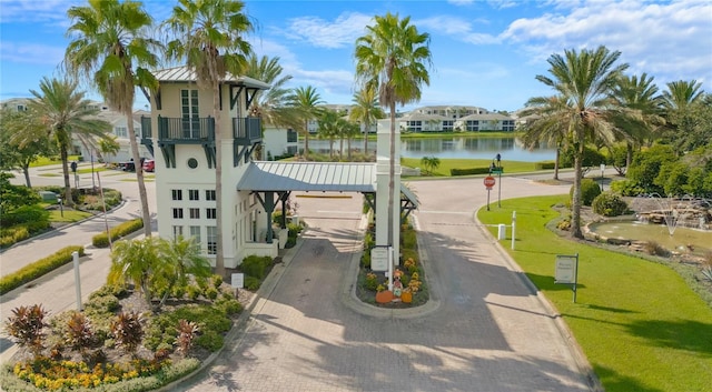 view of home's community featuring a yard and a water view