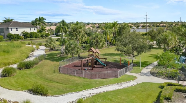 view of property's community featuring a lawn, a water view, and a playground