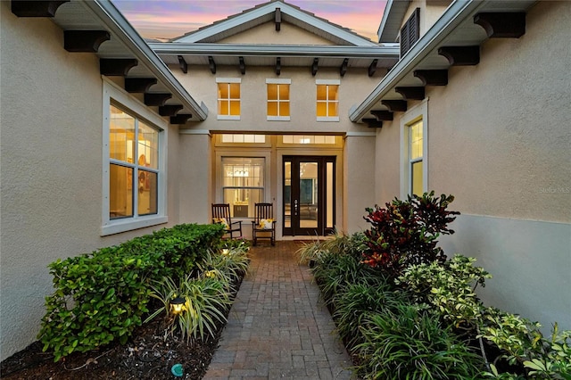 exterior entry at dusk featuring french doors