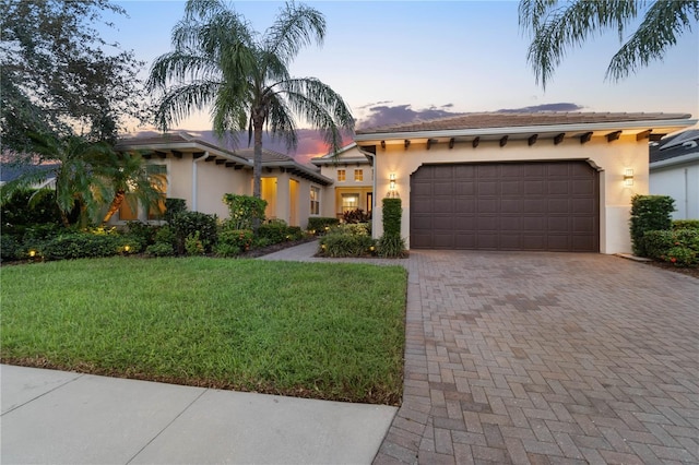 mediterranean / spanish house with a yard and a garage