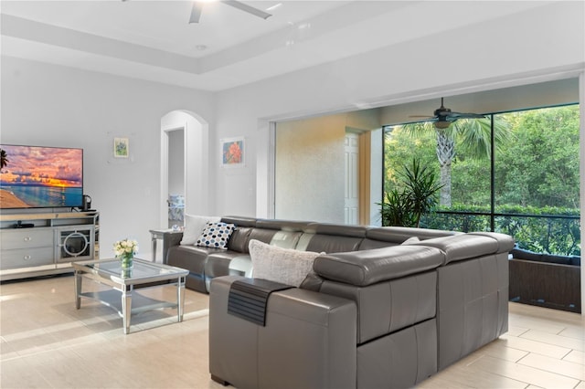 tiled living room with ceiling fan