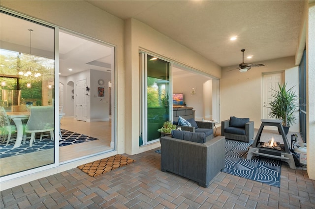 view of patio with a fire pit and ceiling fan